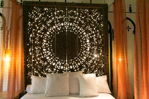 a bed with a head board with lights on it at Lodge K in Marrakech