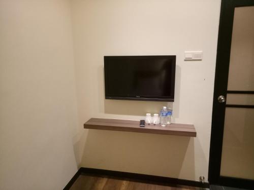 a room with a flat screen tv on a wall at 9 Square Hotel - Seri Kembangan in Seri Kembangan