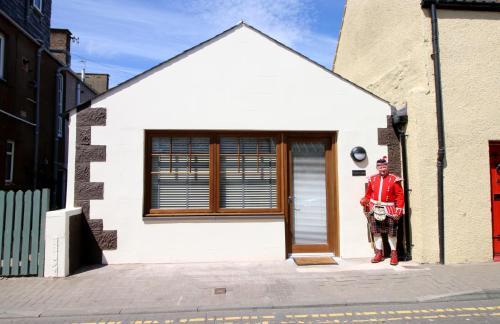 a man standing in front of a building at The Old Brewhouse in Arbroath