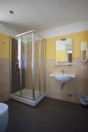 a bathroom with a shower and a sink at Hotel Stella Marina in San Vincenzo