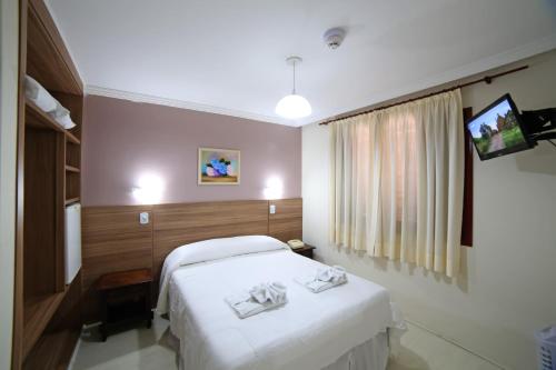 Cama ou camas em um quarto em Hotel JB