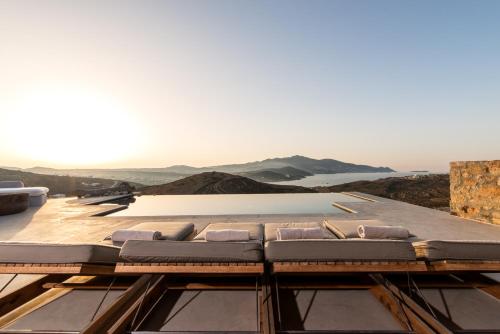 a house on top of a roof with pillows at Villa Amra - Secluded Mykonos Haven with Sea Views, Heated Pool, Gym & Hammam in Elia