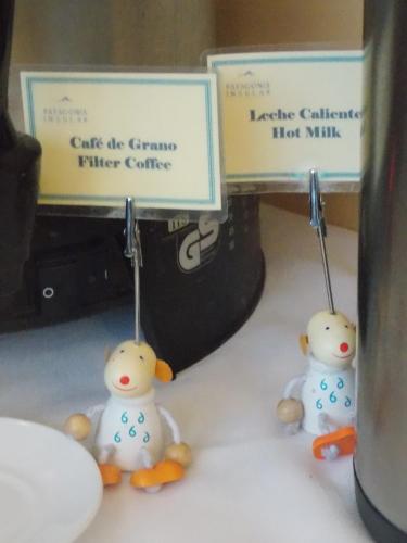 two toy ducks are hanging from a sign at Hotel Patagonia Insular in Quellón