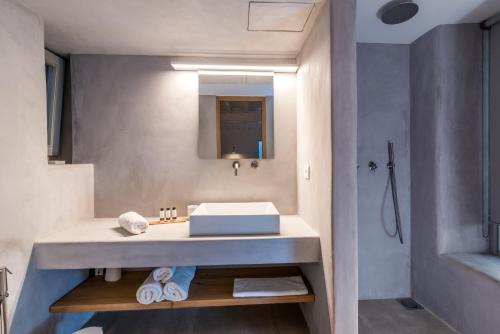 a bathroom with a sink and a mirror at Villa Amra - Secluded Mykonos Haven with Sea Views, Heated Pool, Gym & Hammam in Elia