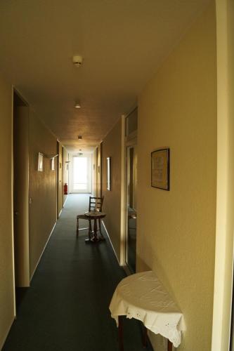 a hallway with a table and a bench in a room at Butjadinger Hof in Burhave
