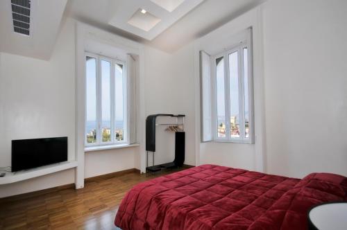 a bedroom with a bed and a flat screen tv at Villa Battista in Ercolano