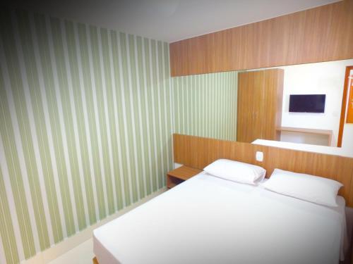 Een bed of bedden in een kamer bij Encontro das Aguas Oficial