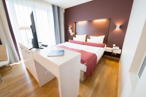 Säng eller sängar i ett rum på Nymphe Strandhotel & Apartments