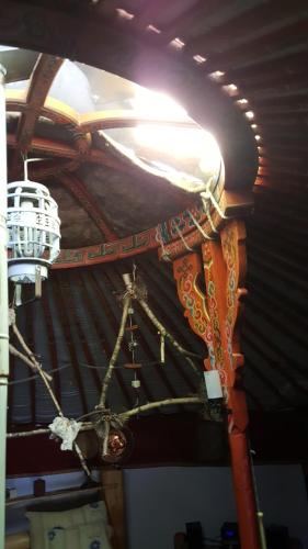 a chandelier hanging from a ceiling in a room at Édes Otthon Vendégház in Nagybörzsöny