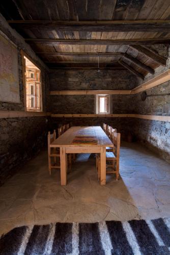 a wooden table and chairs in a room at Кюповата къща 1860 Qpova house in Kovačevica