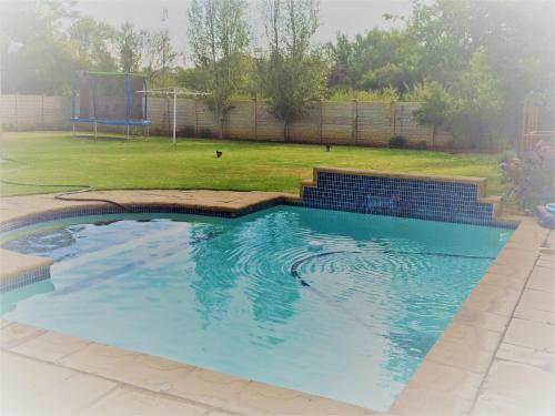 a large swimming pool in a yard at Stel26 in Bloemfontein