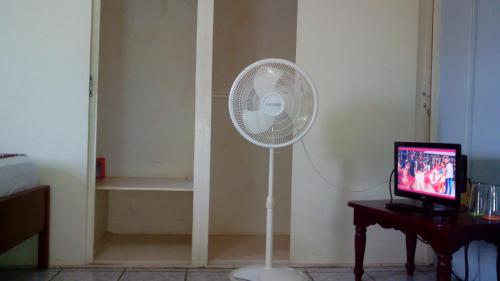 a white fan in a room with a television at Don Santiago Guesthouse Downtown in San Ignacio