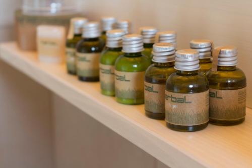 a row of bottles of liquids sitting on a shelf at BÉNI family wine farm in Cegléd
