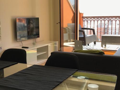 a living room with a couch and a tv at High Rentxacobeo in Sarria