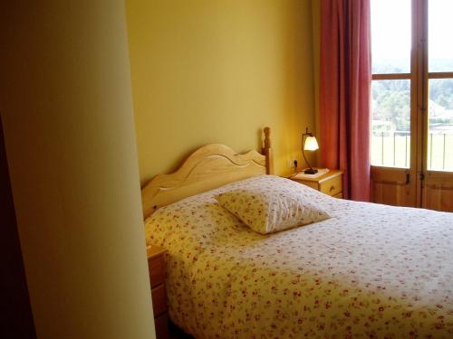 a bedroom with a bed with a pillow and a window at Mansion in Maians with Private Pool in Castellfullit del Boix