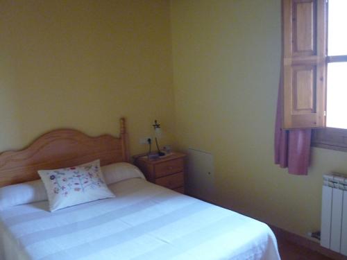 a bedroom with a white bed and a window at Mansion in Maians with Private Pool in Castellfullit del Boix