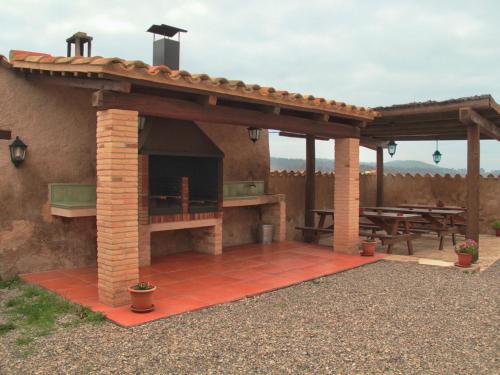 a patio with an outdoor grill and picnic table at Mansion in Maians with Private Pool in Castellfullit del Boix
