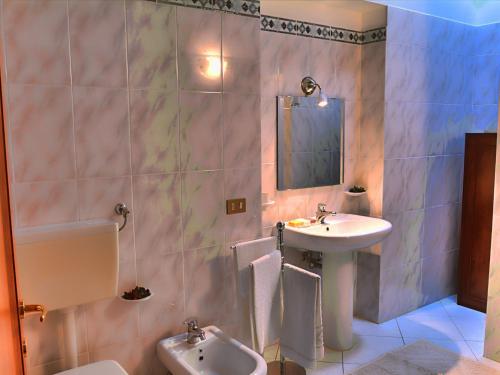 a bathroom with a sink and a toilet at Farmhouse in Campriano in Chiassa Superiore