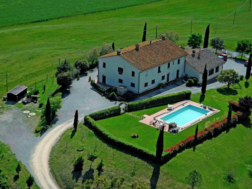 an aerial view of a house with a swimming pool at Authentic farmhouse in the Val D Orcia with pool and stunning views in Contignano
