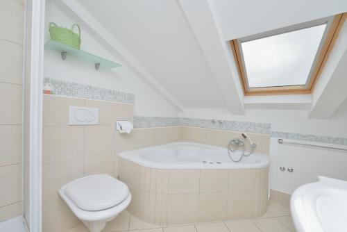 a bathroom with a tub and a toilet and a sink at Villa Dalmatina Zadar mit Pool in Zadar