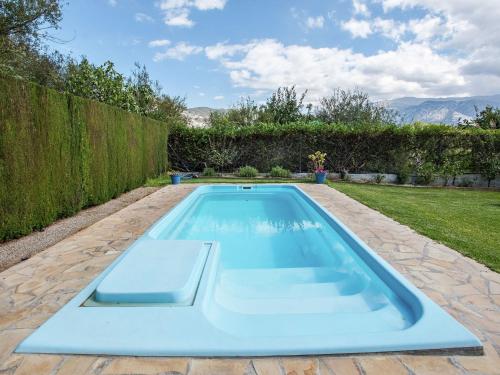 a swimming pool in the backyard of a house at Belvilla by OYO Molinos de Padul Se a Anica in Padul