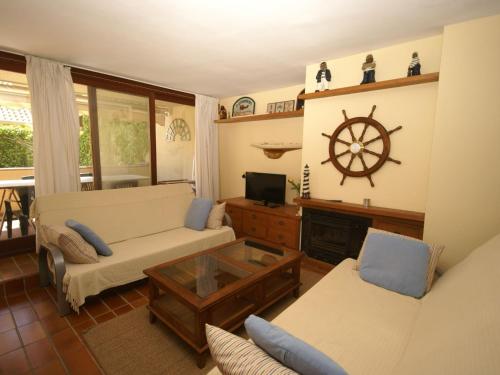 a living room with a couch and a table at Inviting Apartment in Playa de Pals with Pool in Begur