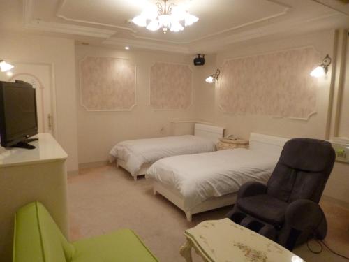 Postel nebo postele na pokoji v ubytování Hotel Sha La La