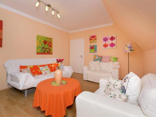 a living room with two white couches and a table at Cozy Holiday Home in Niedersalwey with Sauna in Eslohe