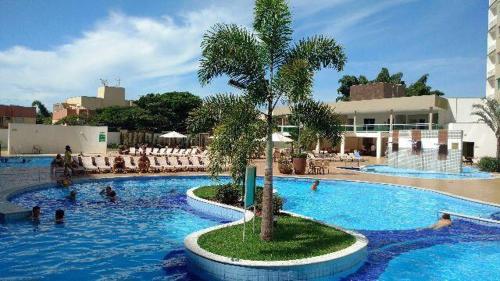 a swimming pool with people in the water at a resort at Prive Riviera Park in Caldas Novas