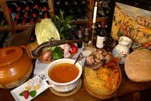 a table with a plate of food and a cup of soup at Hostería Camino in Luyego de Somoza