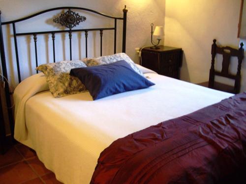 a large bed with two pillows on top of it at Rural Farmhouse in Valencia de Alc ntara with Pool in La Borrega