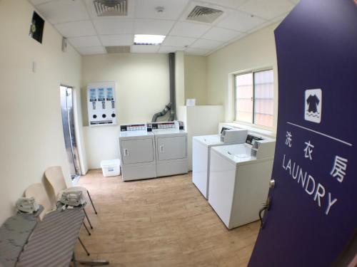 a room with washing machines and appliances in a room at Airline Inn Green Park Way in Taichung