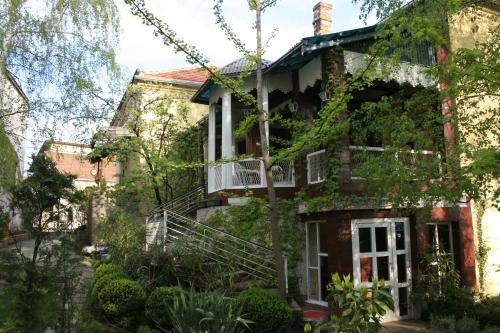 an exterior view of a house with trees at Base for Adventurers - Urban Guerrilla in Negotin