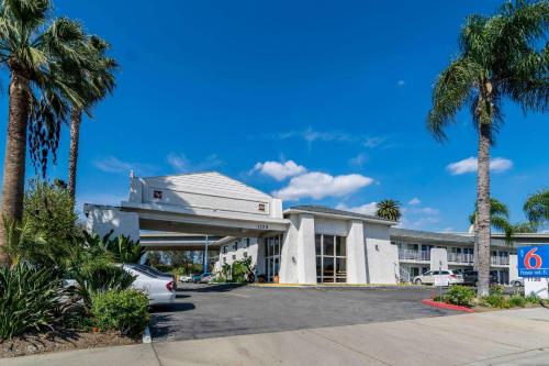 a building with palm trees in front of it at Motel 6-Redlands, CA in Redlands
