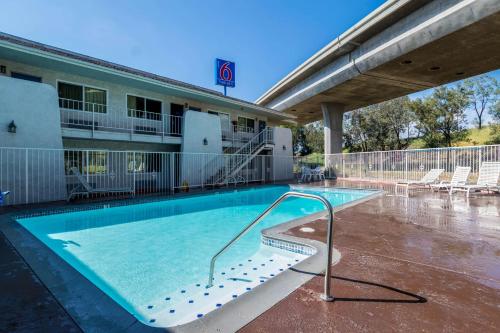 a large swimming pool in front of a building at Motel 6-Redlands, CA in Redlands