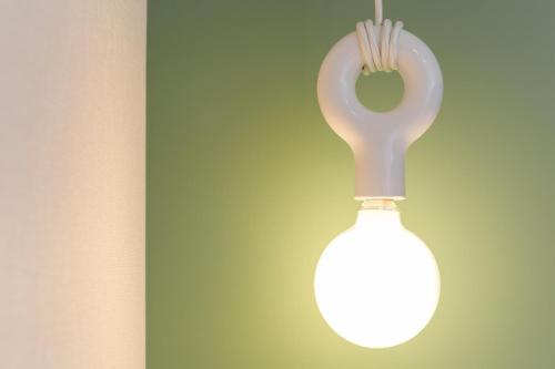 a white light bulb hanging from a wall at Hotel M's Est Shijo Karasuma in Kyoto