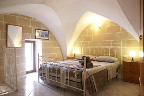 Krevet ili kreveti u jedinici u okviru objekta Corte De Noie Appartamenti Gallipoli