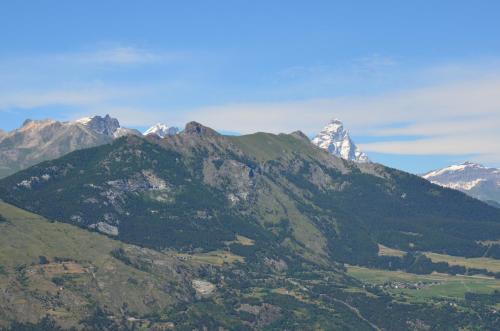 a mountain range with snow capped mountains in the background at Confrérie du Moyen Âge in Verrayes