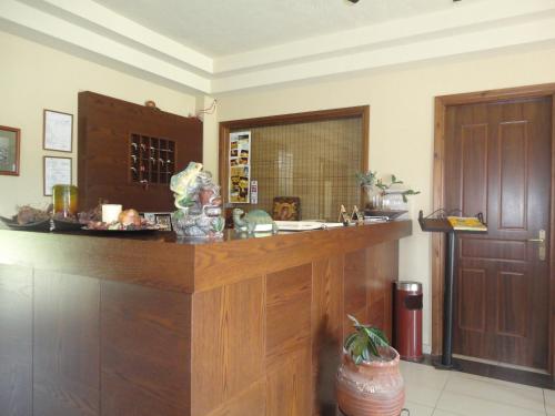 a kitchen with a counter with a sink and a door at Archontiko Liamas in Stavros