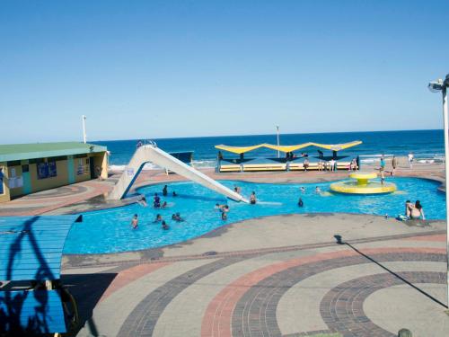 a group of people in a swimming pool near the ocean at JoThams Bed & Breakfast or Self-catering in Durban