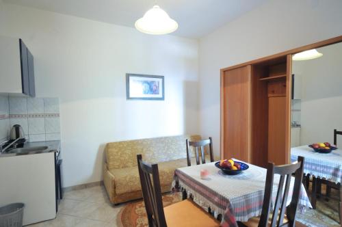 a kitchen and a dining room with a table and a table and a tableablish at Apartments Balic in Sveti Stefan