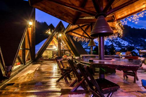 a room with a table and chairs and a bell at Resort Cheile Gradistei Moieciu in Moieciu de Sus