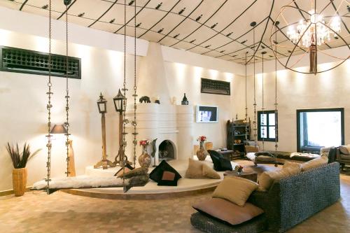a living room with a couch and a fireplace at Lodge K in Marrakech