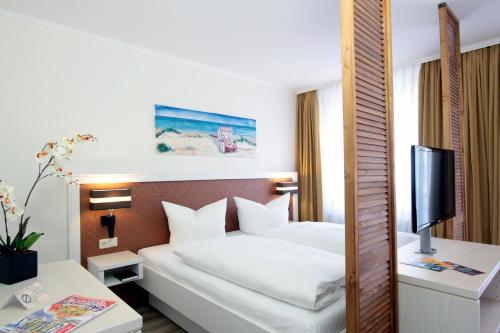 מיטה או מיטות בחדר ב-Park Hotel Sellin