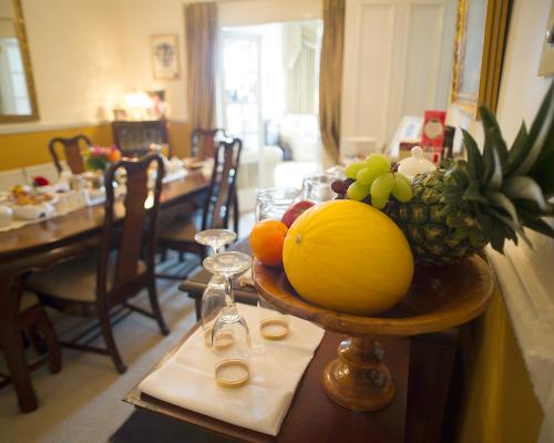 a table with a bowl of fruit on a table at Craig Park House in Airdrie