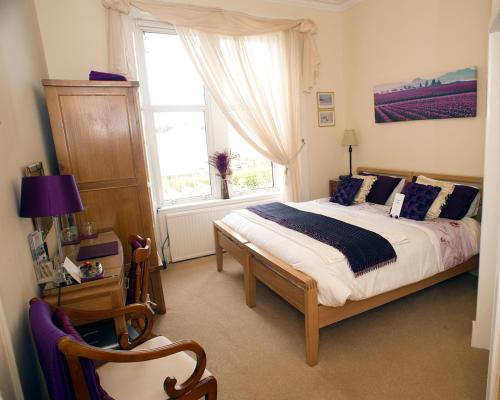 a bedroom with a large bed and a window at Craig Park House in Airdrie