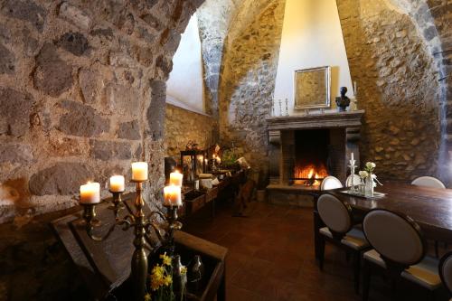 a dining room with a fireplace in a stone wall at Castello di Limatola in Limatola