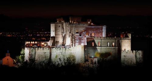 a castle is lit up at night at Castello di Limatola in Limatola