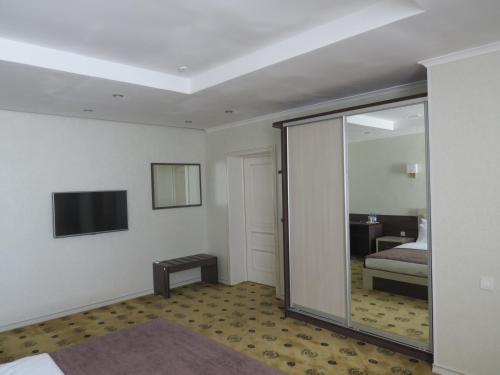 a hotel room with a bed and a sliding glass door at Luxury House in Shymkent