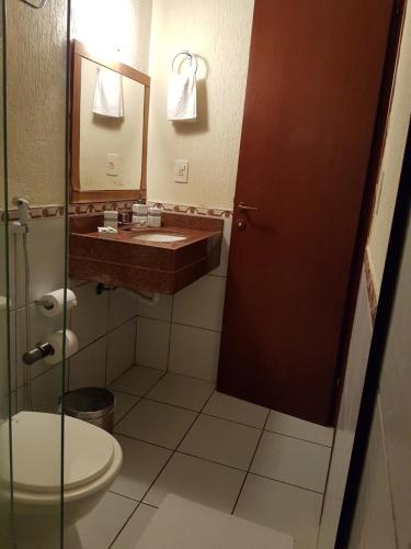 a bathroom with a sink and a toilet at Vilamar Suítes in Aquiraz